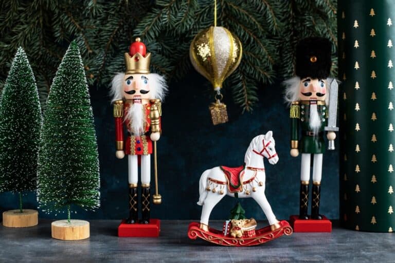 Christmas nutcrackers next to a toy horse and fake trees
