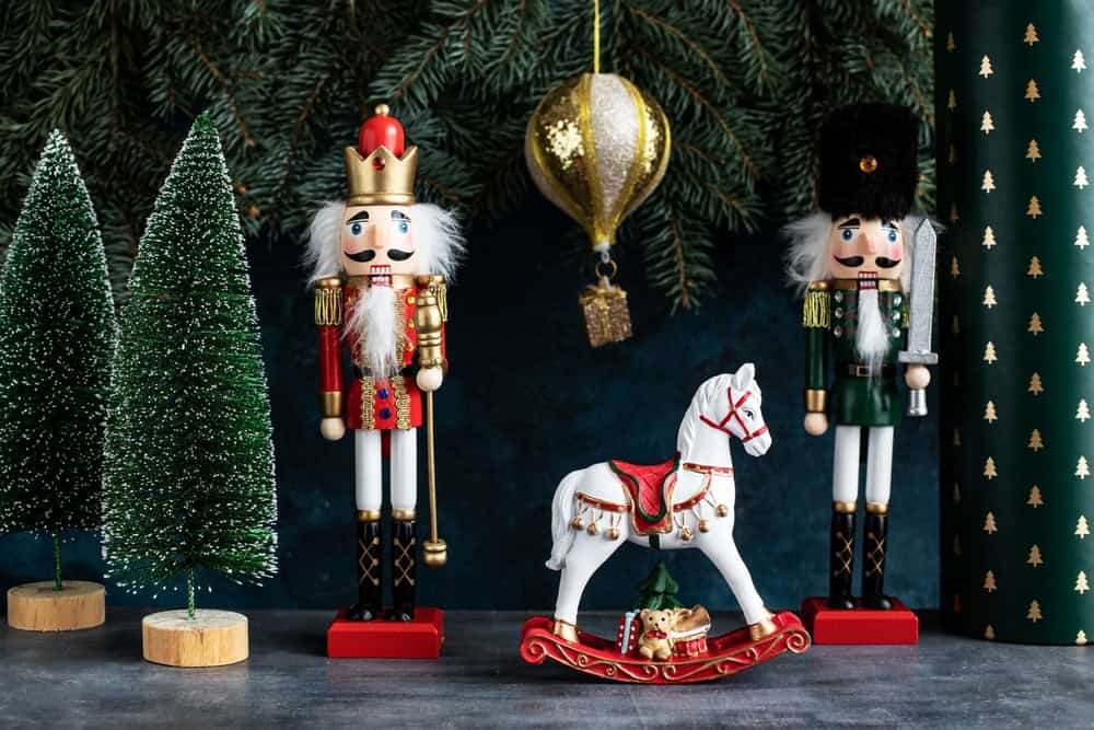 Christmas nutcrackers next to a toy horse and fake trees