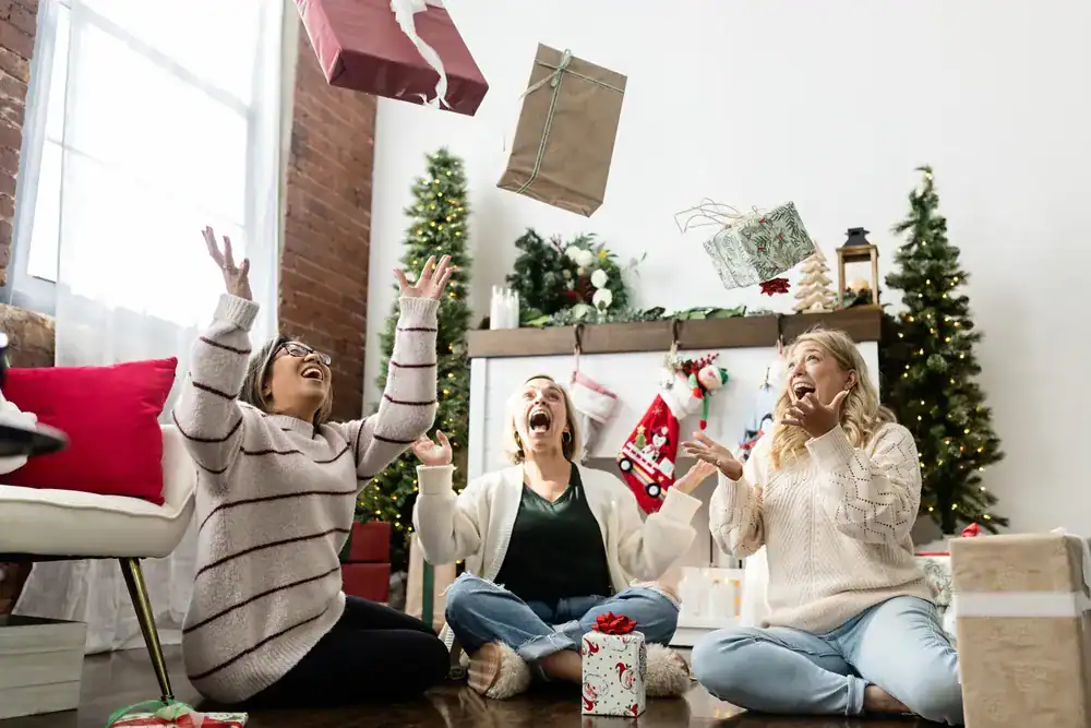 three women feeling very excited after exchanging gifts on Christmas