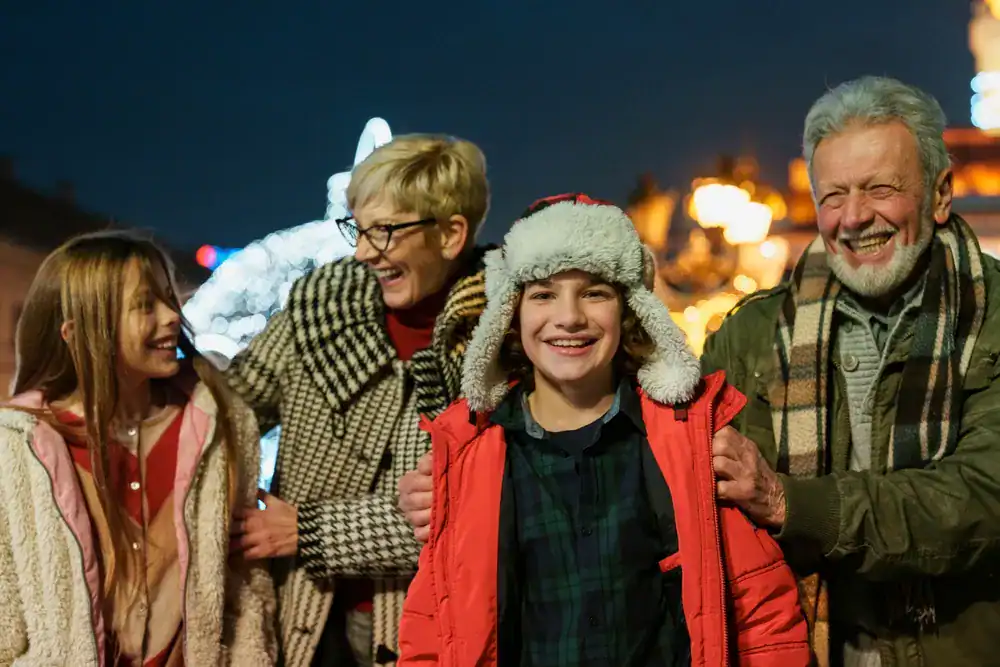 grandparents with their grandchildren outdoors during the Christmas season
